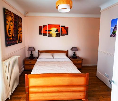 a bedroom with a bed and two night stands at Apakabar Homestay - proche gare Melun, parking privé, Netflix in La Rochette