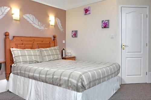a bedroom with a bed and flowers on the wall at Deincourt Hotel in Newark upon Trent
