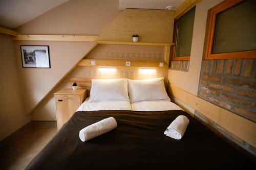 a small bedroom with a bed in a attic at GLUTEN FREE Bed & Breakfast Dežela Okusov in Ljubljana