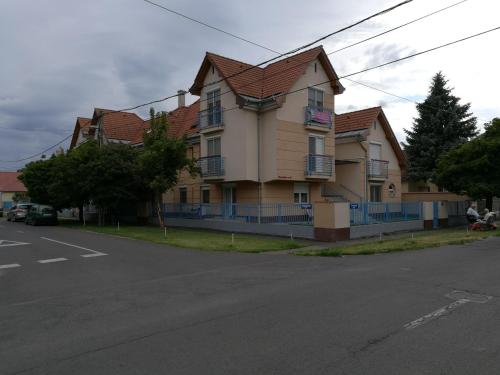 a large house on the side of a street at Kiskuckó Apartman in Hajdúszoboszló
