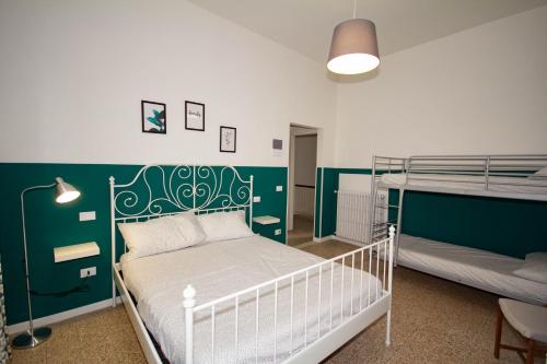 a bedroom with two bunk beds and a green wall at La bicicletta Rossa B&B in Cenaia