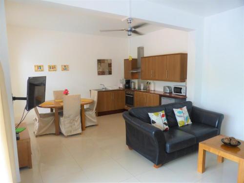 a living room with a couch and a table at Marigot Palms Luxury Caribbean Apartment Suites in Marigot Bay