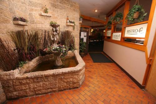 a lobby with a fountain in the middle of a building at Travelodge by Wyndham Brandon in Brandon