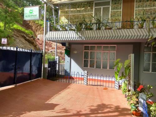 a house with a gate in front of it at Latei Ville Inn in Shillong
