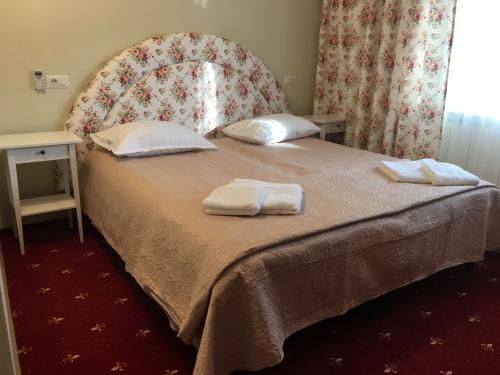 a bedroom with a bed with two towels on it at Casa Bucovineana in Suceava