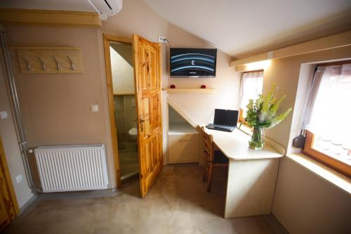 a tiny house with a desk and a laptop on it at GLUTEN FREE Bed & Breakfast Dežela Okusov in Ljubljana