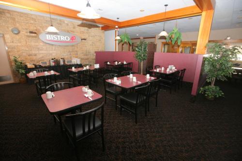 a dining room with tables and chairs in a restaurant at Travelodge by Wyndham Brandon in Brandon