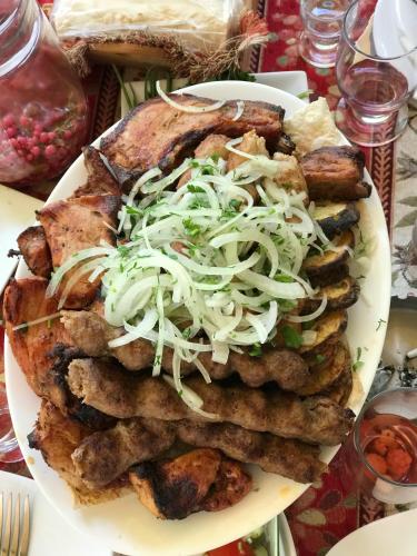 a plate with a pile of food on a table at COMMUNE hotel in Garni