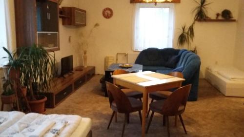 a living room with a table and a couch at Apartment Rychtrovna in Hejnice