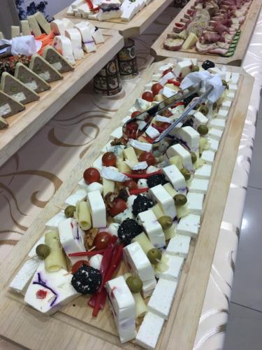 a display of cheese and other appetizers on a table at Casa Bucovineana in Suceava