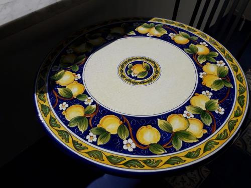 a blue and white plate with lemons on it at Maiori Apartment by Marcel in Maiori