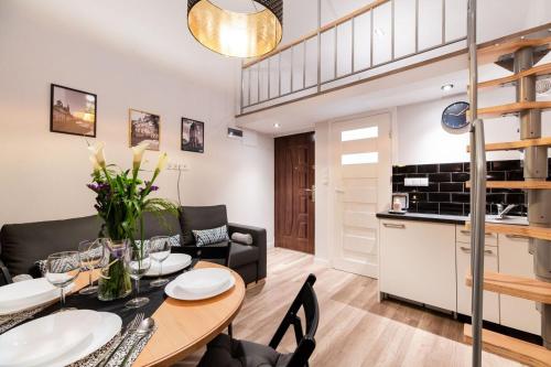 a kitchen and living room with a table and chairs at DIETLA 99 APARTMENTS - IDEAL LOCATION - in the heart of Krakow in Kraków