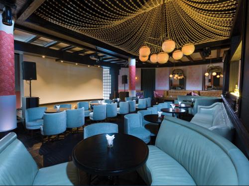 a restaurant with blue chairs and tables and a stage at Unico Hotel Riviera Maya Adults Only in Akumal