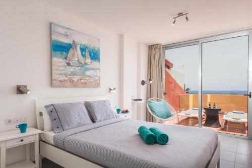 a bedroom with a bed and a view of the ocean at Ocean View Penthouse II in Gran Tarajal