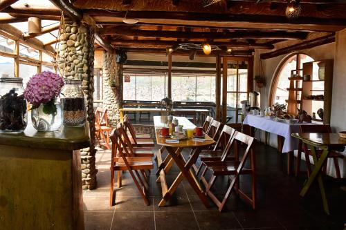 a restaurant with tables and chairs in a room at La Casa de Campo in Cusco