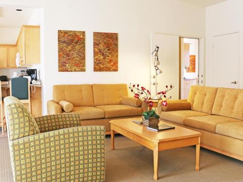 a living room with two couches and a coffee table at Raintree's Cimarron Golf Resort Palm Springs in Cathedral City