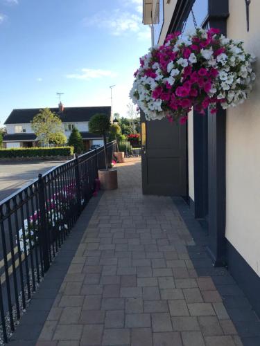 a door with a bunch of flowers hanging from it at The Brandywell in Dromod