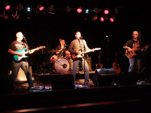 a group of people on a stage playing instruments at Travelodge by Wyndham Brandon in Brandon