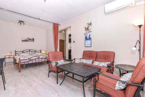 a room with a bed and a table and chairs at Visit Sofia Macedonia Square Central Apartment by Flat Mаnager in Sofia