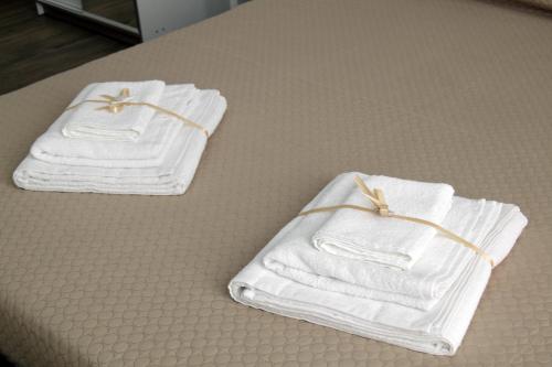 two towels are sitting on a table at Barnab@House in Monopoli