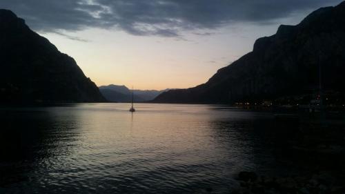 a sailboat in the middle of a lake at sunset at Casa al Lago in Lecco