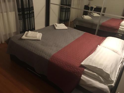 a bedroom with a bed with two towels on it at Casa Bucovineana in Suceava