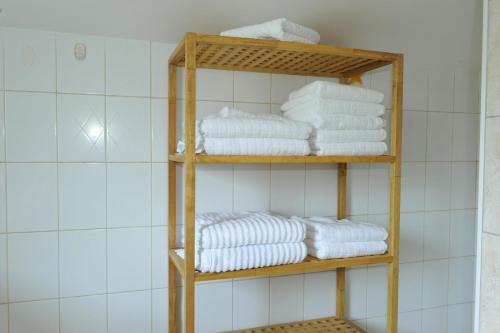 a stack of towels on a shelf in a bathroom at Apartman Branka in Kornić