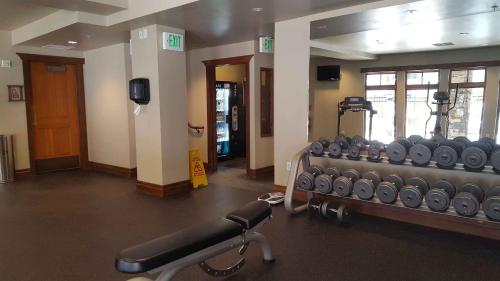 a gym with a row of treadmills in a room at Raintree's The Miners Club Park City in Park City
