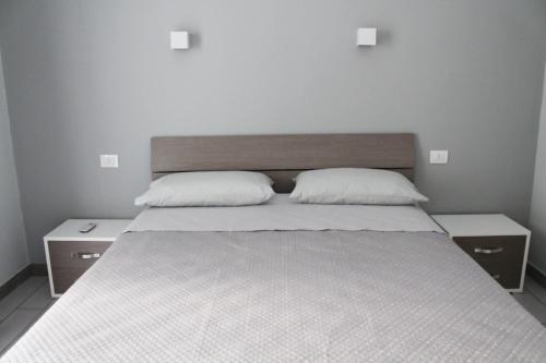 a bedroom with a large bed with two pillows at B&B La casa di Cò in Naples