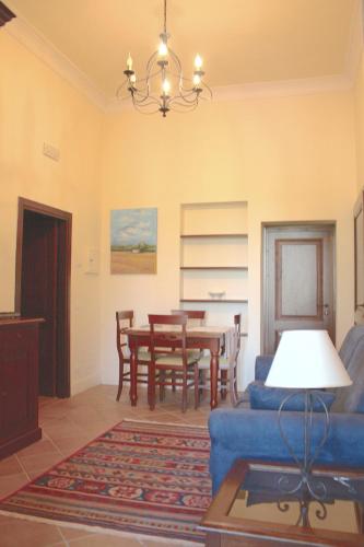 a living room with a blue couch and a table at Residenza Porta Guelfa in Bevagna