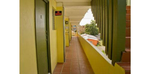 an empty hallway of a building with green and yellow walls at Meridian Inn in Christ Church
