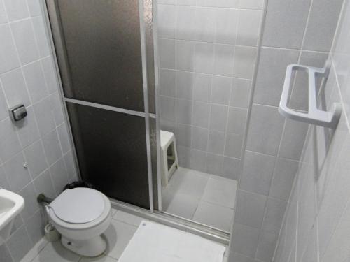 a bathroom with a shower with a toilet and a sink at Edificio Edmeia in Praia Grande