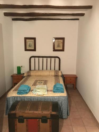 a bedroom with a bed with blue towels on it at Apartament Cala Magda Sant Llorenç de Montgai in Sant Llorenç de Montgai
