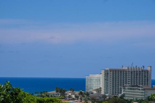 een uitzicht op de oceaan en een hoog gebouw bij Hillview At Mystic Ridge in Ocho Rios