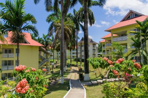 a resort with palm trees and a pathway at Hillview At Mystic Ridge in Ocho Rios