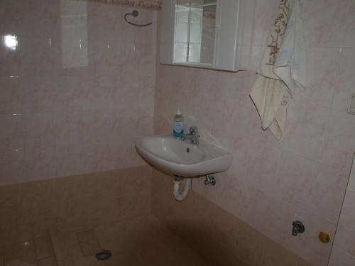 a bathroom with a sink and a mirror at Kokagia House in Cherronisos