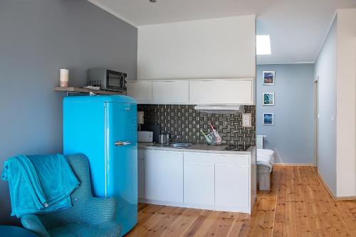 a kitchen with a blue refrigerator in a room at Villa Koffi Apartments 16 plus in Puck