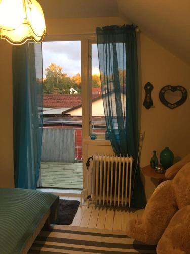 a bedroom with a bed and a window and a radiator at Kolstigenhus in Fågelfors