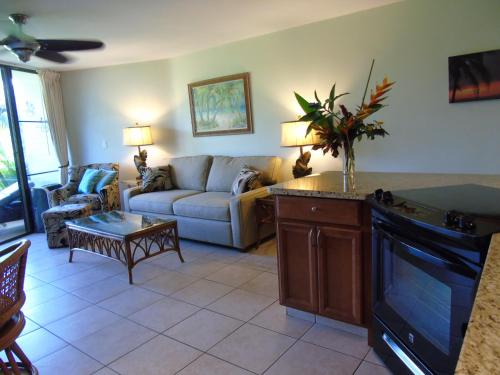 a living room with a couch and a table at Aloha KAI - Resort Condo in Kihei