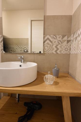 a bathroom with a white sink and a mirror at Turiddu B&B in Catania