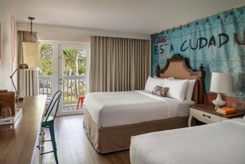 a hotel room with a bed and a desk at Havana Cabana at Key West in Key West