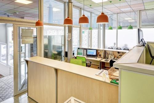 an office with a counter and desks and chairs at Hotel AQUARELLE (East of Moscow) in Moscow