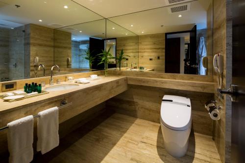 a bathroom with a toilet and a large mirror at Swissotel Lima in Lima