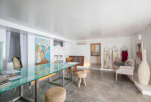 a room with a glass table and some furniture at Kalestesia Suites in Akrotiri