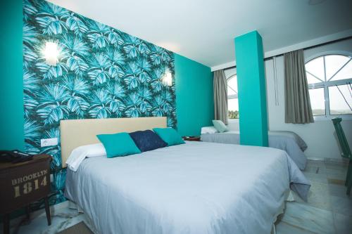 Postel nebo postele na pokoji v ubytování Hotel Nómadas