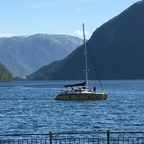 a boat floating on a large body of water at Sogn Hotel in Vadheim