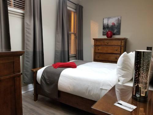 a bedroom with a bed with a table and a dresser at 1-Bedroom Cozy #18 by Amazing Property Rentals in Gatineau