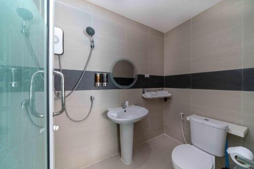 a bathroom with a shower and a toilet and a sink at Coconut Palms in Kantharawichai