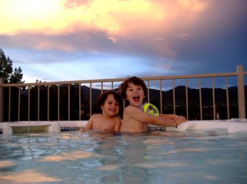two young boys in a swimming pool at La Dona Luz Inn an Historic B&B in Taos