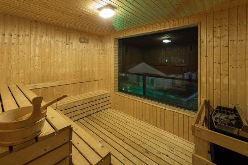 a wooden sauna with a large window in it at Jinhold Hotel & Serviced Apartment in Miri